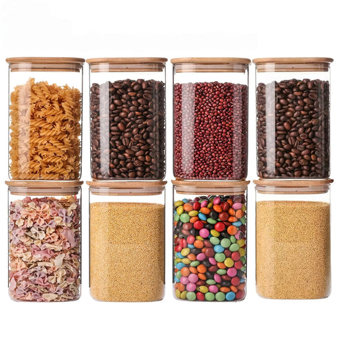 Minimalistische glazen voorraadpotten met bamboe deksels voor een stijlvolle en duurzame keukenorganisatie.