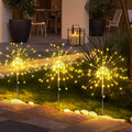 Decoratieve solar tuinlampen met vuurwerkdesign en automatische verlichting op zonne-energie.